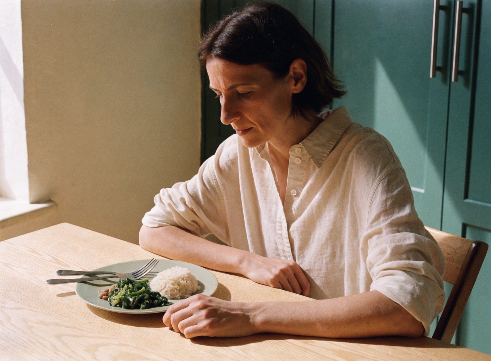 Woman taking a break during a meal at home.